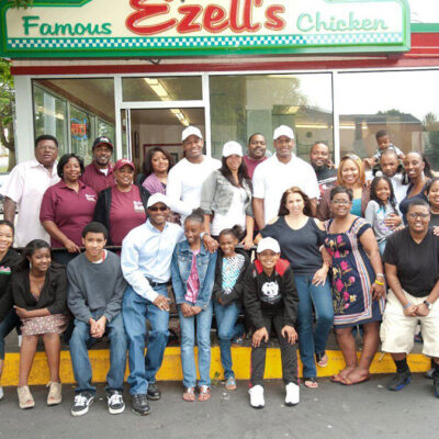 Ezell's Famous Chicken family in front of restaurant